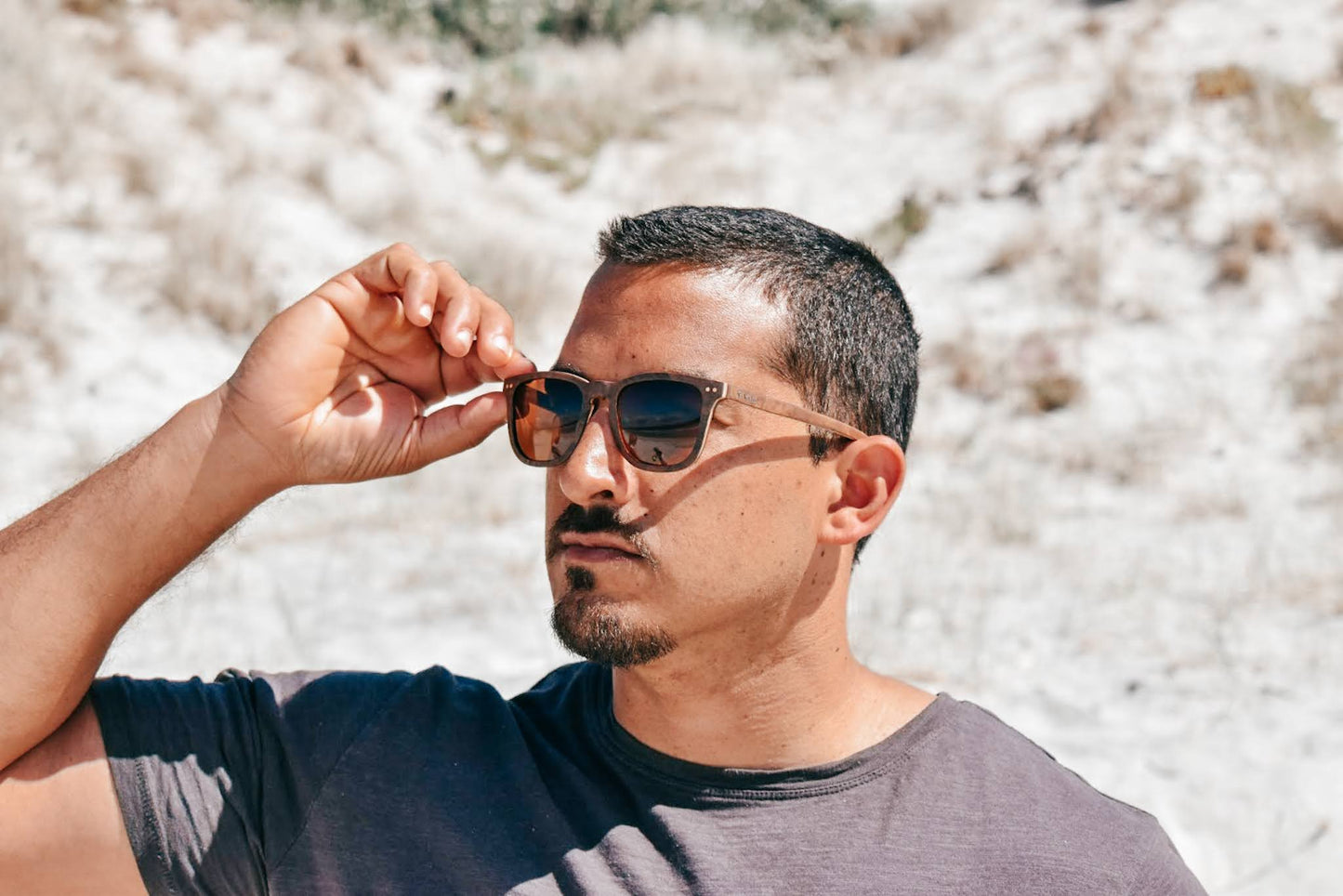 Man wearing Vilo Angelou Wooden Sunglasses on the beach